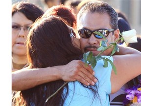 Jimmy Crowshoe, the father of Colton Crowshoe, is hugged as he arrives at a vigil for his son Colton Crowshoe at the Abbydale Community Centre field on Sunday evening.