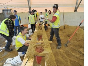 John Lucas/Postmedia News 
 Red Deer city workers fill sand bags in the city yard in Red Deer on Friday.