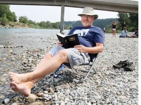 John Van Sloten, pastor at New Hope Church in Calgary, relaxes with his Bible at Edworthy Park.