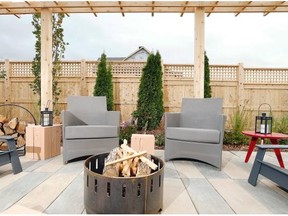 Julie Oliver/Postmedia News This side-yard firepit is framed by cedar pergola and cedar fencing.