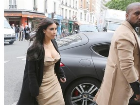Kim Kardashian, left, and Kanye West shop in Paris in the days leading up to their wedding. Kardashian has reportedly left their honeymoon in Ireland because there wasn’t enough high-end shopping.