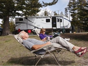 Kathryn and Les Olaski relax with a view of Rundle Mountain while camping at Tunnel Mountain campground in Banff on May 14, 2014.