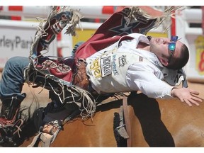 Kaycee Feild of Spanish Fork, Utah, takes a wild ride on Caddy Wagon in the Bareback competition Tuesday at the Calgary Stampede.