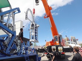 LaPrairie Crane uses its 165-ton crane to move a coil tubing injector off a flatbed at Stampede Park in preparation for the Global Petroleum Show, which begins Tuesday.