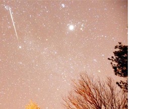 A large meteor streaks across the sky during the annual Geminid meteor shower over Springville, Ala., in 2012. NASA says North America could be treated to a large meteor shower Saturday morning. (AP Photo/AL.com)