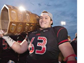 Laval Rouge et Or offensive lineman Pierre Lavertu raises the Dunsmore Cup after defeating Montreal Carabins in CIS football for the RSEQ final last November. The Stamps traded with Ottawa to land the right to pick Lavertu first overall in Tuesday night’s CFL draft.