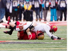 Laval Rouge et Or quarterback Alexander Skinner is tackled by University of Calgary Dinos defender Thomas Spoletini during the 2013 Vanier Cup last November. Spoletini is back for no other reason than the unfinished business of winning a national title.