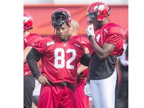 Nik Lewis, left, seen talking shop with Jeff Fuller during Stamps training camp last week, will be voting ‘no’ on the deal that the CFL and CFLPA struck.