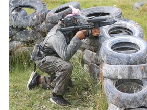 Nik Lewis takes cover as the Calgary Stampeders took in some team bonding at Capture the Flag Paintball in Cochrane on Tuesday. The squad is back on the practice field on Wednesday morning in preparation for Sunday’s game in Ottawa.