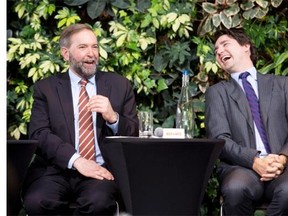 Liberal Leader Justin Trudeau laughs with NDP Leader Tom Mulcair during a panel discussion on youth voting last March in Ottawa.