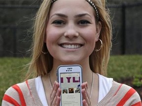 In this April 23, 2014 photo, Melissa Ellard poses showing her Hinge profile on her iPhone, in Foxborough, Mass. Ellard says she wouldn’t have gone on a date in the past six months were it not for Hinge, a dating app whose promise hinges on its ability to hook you up with friends of friends. (AP Photo/Charles Krupa)