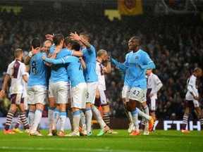 MANCHESTER, ENGLAND - MAY 07:  Edin Dzeko of Manchester City is mobbed by team mates after scoring his team's second goal during the Barclays Premier League match between Manchester City and Aston Villa at Etihad Stadium on May 7, 2014 in Manchester, England.  (Photo by Michael Regan/Getty Images)