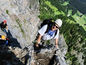 Marc Moquin, followed by Holly Brown and Herald reporter Reid Southwick, climb up the via ferrata at Mount Norquay. Via ferrata or “iron road” originated in Europe and uses steel cables to create a protected climbing route for steep rock often with steel steps and other aids.