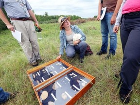 Margie Patton shows off some of the artifacts uncovered at the Cluny Fortified Village archaeological excavation, a 300-year-old settlement at Blackfoot Crossing Historical Park on the Siksika Nation.