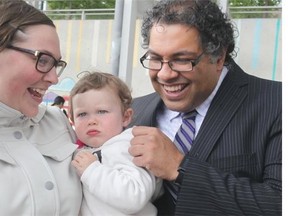 Mayor Naheed Nenshi tries to coax a smile out of Huxley LeClair Meadows alongside her mom Devon LeClair while being greeted by the public prior to a ceremony at Bridgeland Market Thursday. The family was flooded in a low lying area of Bridgeland last June.