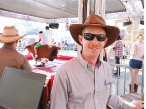 Mechanical bull operator Loyd Herrington at his booth on the Calgary Stampede midway.