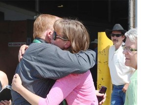 Melissa Haroldson is given a hug as the chuckwagon community rallies around her and husband Tim, as their racing team and gear were auctioned after they made a decision to retire. Veteran driver Tim Haroldson was unable to attend the auction as he was in hospital after a chuckwagon training incident earlier in the week at the Stampede.