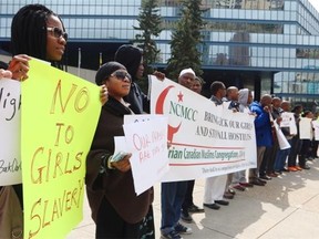 Members of Calgary’s Nigerian community gathered on the steps of City Hall to hold a rally to raise awareness about the 200 school girls kidnapped in their home country. 
 (Colleen De Neve/Calgary Herald)