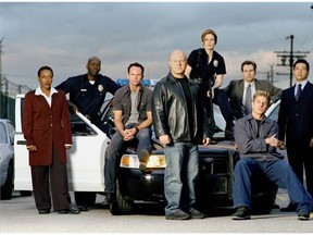 Michael Jace, second from left, poses with the cast of The Shield. The 50-year-old actor is being questioned after his wife April Jace was found dead in their south Los Angles home on Monday. (Courtesy of FX)