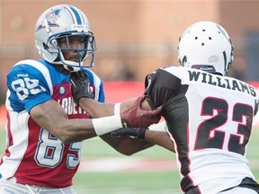 Montreal Alouettes receiver Chad Johnson, left, seen battling Ottawa’s Seth Williams during pre-season action earlier this month, will be making his CFL regular-season debut in Calgary on Saturday and the Stamps plan to be ready for the former NFL star.