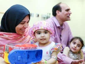 Nazdana, front right, with her mother, Alia Jouhar, while her father, Jouhar Ali and big sister, Paghunda, 4, sit behind at the Alberta Children’s Hospital.