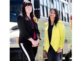 Neha Khare, CrossIron Mills marketing director, right, and tourism manager Kayla Seib, in front of a shuttle bus.