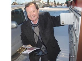 Neil Kenyon retrieves his mail at a Canada Post superbox in his Applewood neighbourhood Thursday.