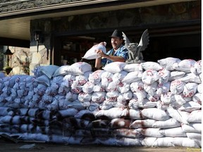 Fred Bohne sandbags his home on Red Deer Drive  in Medicine Hat, Alberta on June 23, 2013 and says he is not leaving.