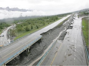 Road damage is shown looking west along the Trans-Canada Highway in Canmore on Friday. Damage to the highway has been the greatest in the Canmore area.