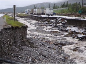 Photo shows how the Cougar Creek current had split in the early hours of Thursday morning, some going right over the highway but much of it going along the median creating a three metre deep trench in between the lanes about 400 metres long to the East of Cougar Creek spilling between the bridge spans over the 1A Highway onto the road below.