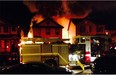 A blaze that broke out in two garages early Tuesday morning in Coventry Hills caused damage to five houses.