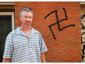 Calgary,Alberta; Aug 2, 2014 -- Mike Dawson discovered graffiti, including a swastika, spray painted on his house early Saturday morning. Police are investigating as this and other homes in the Sundance and Midnapore areas were victimized. ({David Moll}/Calgary Herald) For Calgary story by {  }