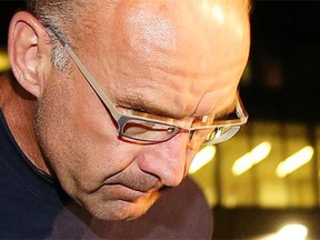 Facing multiple murder charges, Douglas Garland is under arrest and escorted to Calgary Police Processing Unit late Monday evening July 14, 2014.