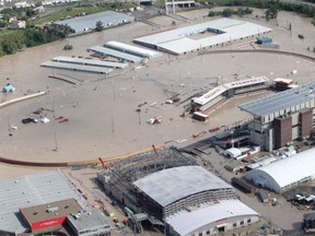 The Stampede grandstand and adjacent grounds lie under the waters of  the Elbow River as seen from the air Friday June 21, 2013.