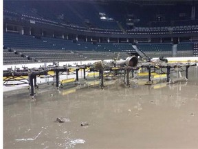 Muck from floodwaters can be seen on Saddledome seating several rows above floor level.