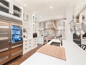 The Dream Home kitchen has maple cabinets, whike oak hardwood, gas range, white subway tile and a walnut butcher's block on top of the island. In addition, it has a wine fridge and a herb fridge -- and a built-in coffee station.