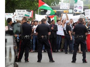 Tempers flared between pro Palestinian and pro Israeli protesters who took to the steps of Calgary City Hall on July 18, 2014. A number of skirmishes broke out between the two factions as the group was protesting Israel's bombing of Gaza.
