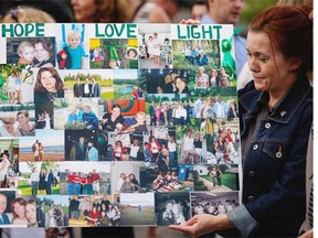 A photo collage of the Liknes and O'Brien family is displayed as neighbors, friends and relatives hold a candlelight vigil for missing Calgarians Nathan O'Brien, five, and his grandparents Alvin and Kathryn Liknes Thursday, July 10, 2014.