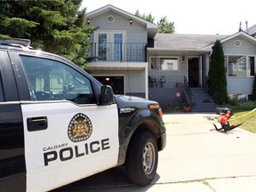 Members of the Calgary Police Service at the home of Alvin and Kathryn Liknes scouring the home for evidence in their missing persons case July 12, 2014. The pair along with their 5-year-old grandson Nathan O'Brien went missing June 29. (Colleen De Neve/Calgary Herald)