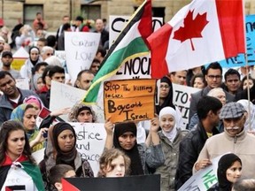 Protesters gather at a rally downtown Friday night.