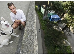 Devin Drewitz and his dog, Jake, pose for a photo near the ledge at BC Place plaza where Jake suffered injuries from jumping over the rail and falling 11 m to the ground below.