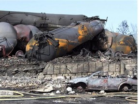 Wrecked oil tankers and debris from a runaway train in Lac-Megantic, Que. are pictured July 8, 2013. Periodic flurries of federal regulation, rule-making and reassurance followed the rail disaster last July that killed 47 people, destroyed dozens of buildings and contaminated waterways in a small Quebec town. THE CANADIAN PRESS/ho, SQ