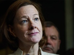 Alison Redford faces media following a meeting of the provincial PC Party executive in Calgary, Alta., Saturday, March 15, 2014 following information that "false passengers" were booked on some government flights so that then-premier Redford could fly alone.