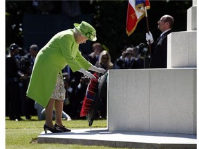 Queen Elizabeth lays a wreath at the foot of the Cross of Sacrifice in the centre of Commonwealth War Graves Commission Cemetery during a remembrance ceremony in France. Reader is disappointed the city is doing nothing to mark the 70th anniversary of D-Day.