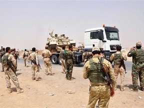 Kurdish security forces deploy outside of the oil-rich city of Kirkuk, 180 miles (290 kilometers) north of Baghdad, Iraq, Thursday, June 12, 2014. The al-Qaida-inspired group that captured two key Sunni-dominated cities in Iraq this week vowed on Thursday to march on to Baghdad, raising fears about the Shiite-led government's ability to slow the assault following the insurgents' lightning gains. Kurdish security forces took over an air base and other posts abandoned by the Iraqi military in ethnically mixed Kirkuk, a senior official with the Kurdish forces said, but he denied they they had taken over the northern flashpoint city. (AP Photo/Emad Matti)