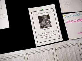 In this Sunday, May 4, 2014 photo, a death notice for musician Wessam Khawees is seen on a message board at art school which adjoins the Damascus Opera House in Damascus Syria. Wessam was killed in a mortar attack on Damascus' outskirts. (AP Photo/Dusan Vranic)
