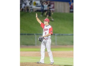 Okotoks Dawgs’ pitcher Shawn Andersen signals to his teammates moments after throwing the winning pitch against the Lethbridge Bulls in Okotoks on Monday night.