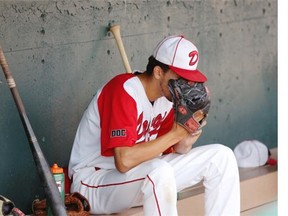 Okotoks Dawgs pitcher Tyrell King takes a moment in the dugout before Game 4 against Medicine Hat on Sunday night.