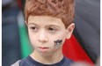 Palestinian supporter Layth Salem, 7, takes part in a rally at City Hall in Calgary on July 25, 2014.