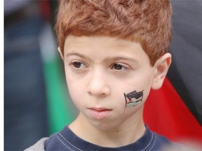 Palestinian supporter Layth Salem, 7, takes part in a rally at City Hall in Calgary on July 25, 2014.